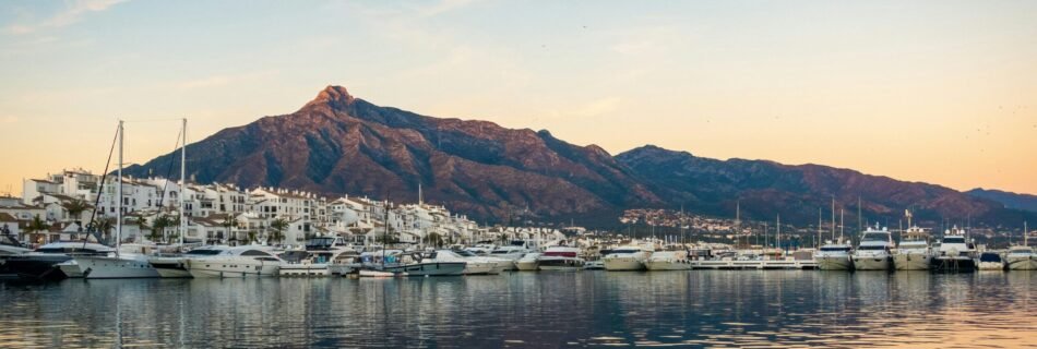white boats on sea near mountain during daytime